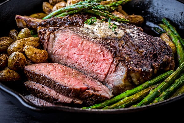 Pepper-Crusted Cowboy Rib Eye Steak with Shiitake Mushroom Butter #steak #recipe #dinner