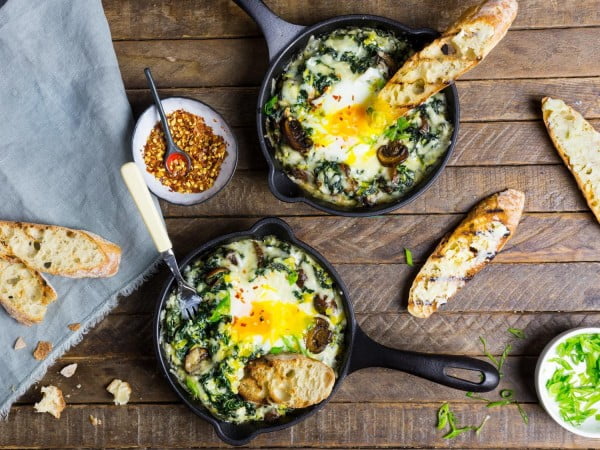 Baked Eggs With Creamy Greens, Mushrooms, and Cheese Recipe #recipe #eggs #breakfast