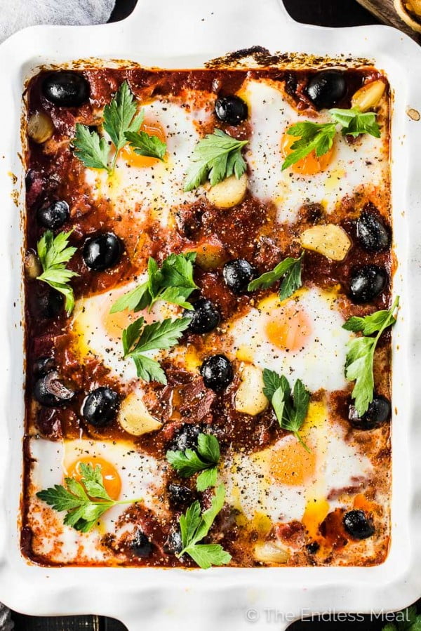 Spanish Baked Eggs with Roasted Garlic and Olives #recipe #eggs #breakfast